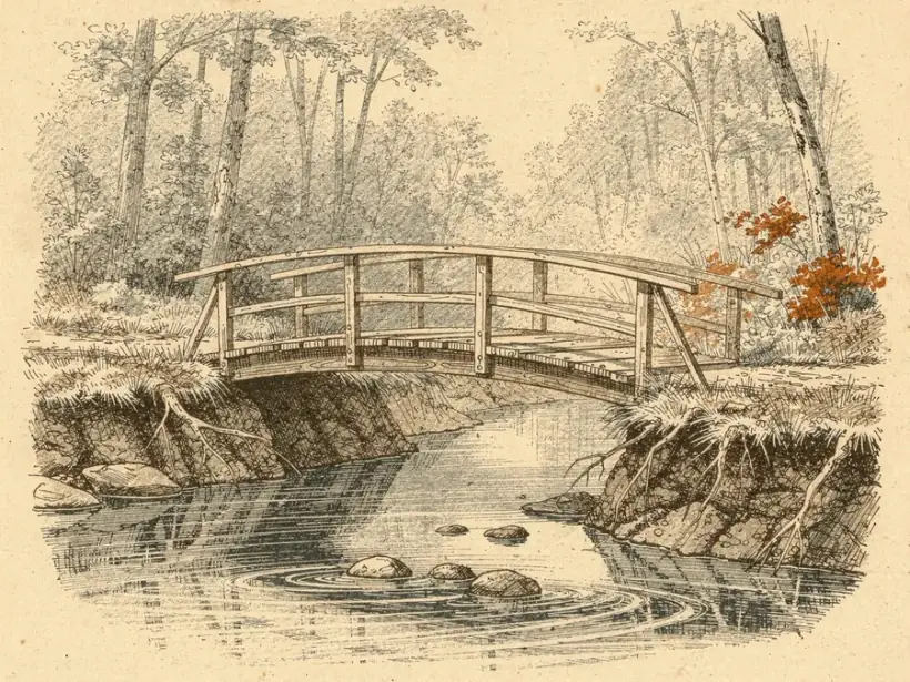 A small wooden footbridge crossing a shallow creek, with low earth banks beneath it.